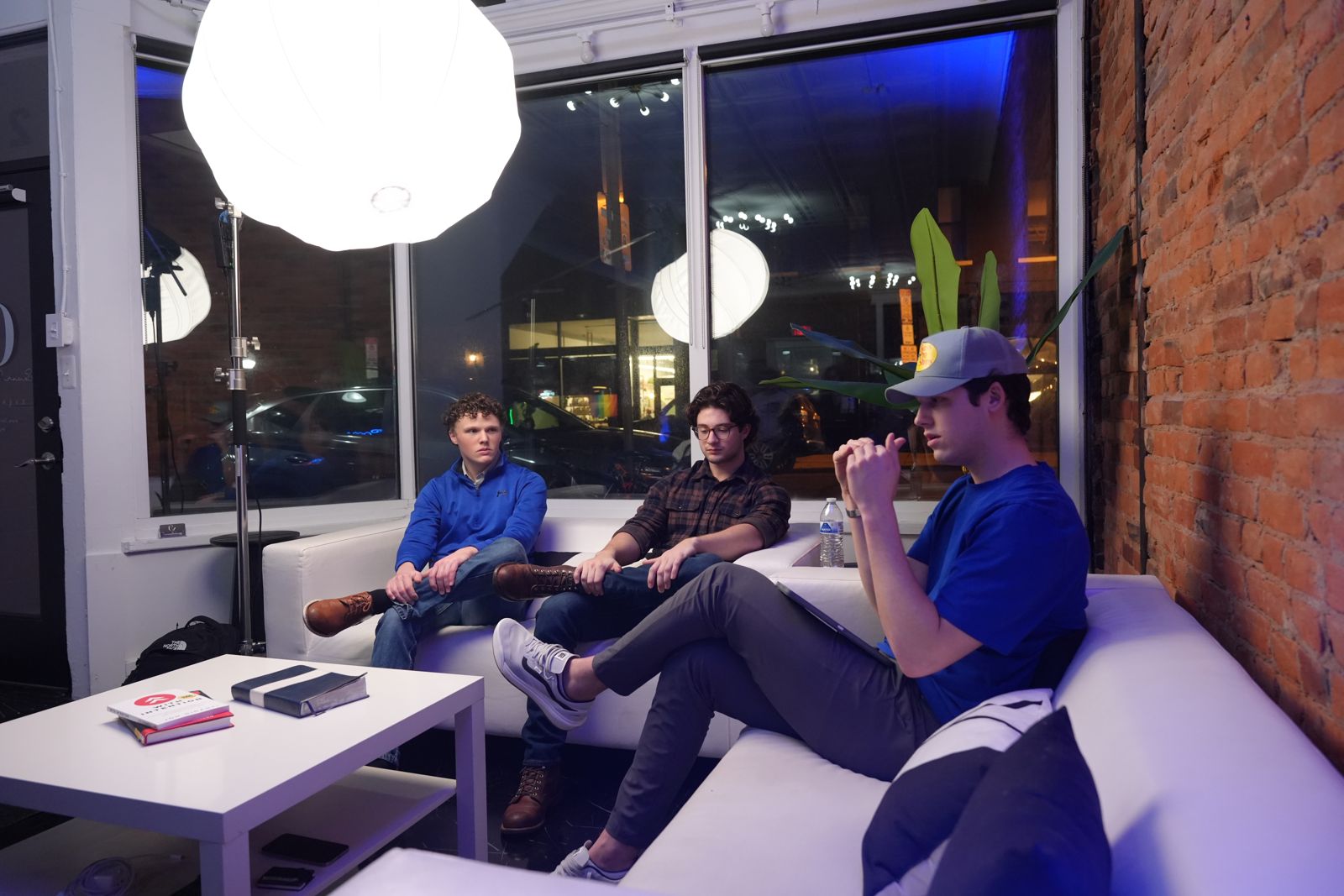 Members in conversation on the couch at a weekly gathering
